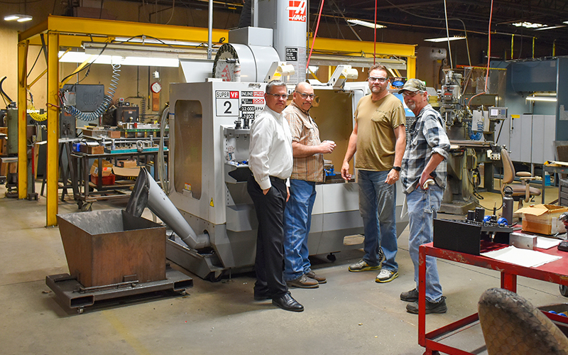 Mike Jensen, President; Jerry Putzier, machinist; Doug Gilbertson, tooling supervisor; and Ken Palmer, tool maker. 