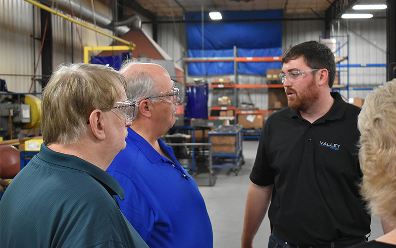 Luke Isensee speaking with Rep. Quam (24A) and Rep. Davids (26B) at Valley Design Enterprises. 